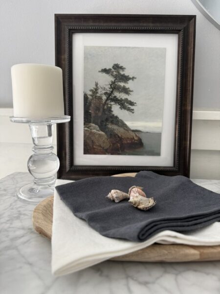 coastal art, glass candle holder with candle, grey and white linen cloths