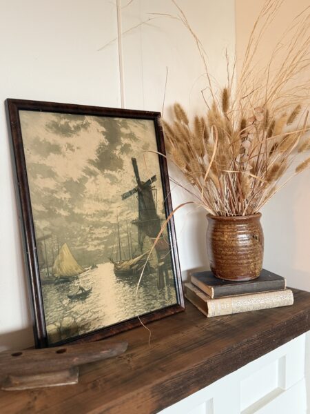 vintage framed picture of windmill and brown pottery vase with dried flowers