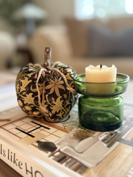 fabric pumpkin and green glass candle holder with candle